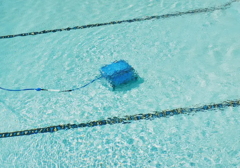 Automatic pool cleaner working on the floor of a pool